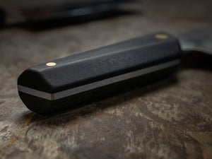 Close up detail of a high quality well made kitchen knife in black from craftsman bud heyser in melbourne Australia