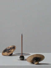 Handcrafted brass incense burners by 13 Knives with flame patina and spherical weighted bases