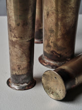 Close-up of hand-forged brass vases by 13 Knives highlighting natural patina, brazed bases, and textured metal surface