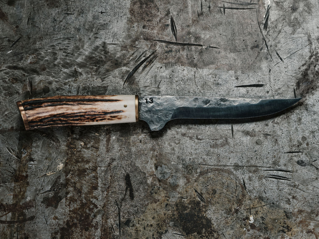 Hand forged high carbon steel boning knife with a stag handle made in melbourne by 13 knives